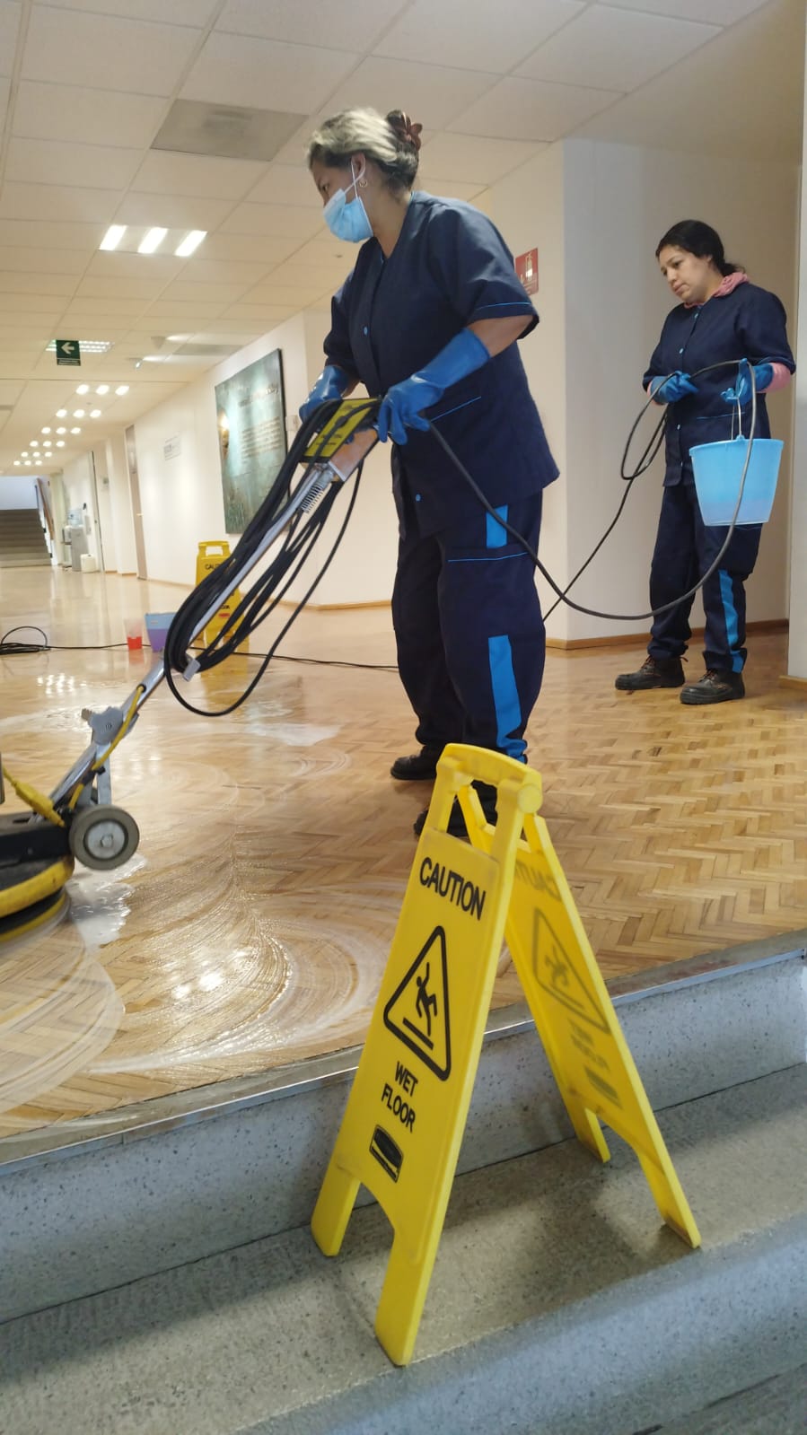 Staff in SELIMEX uniforms using a floor-care machine