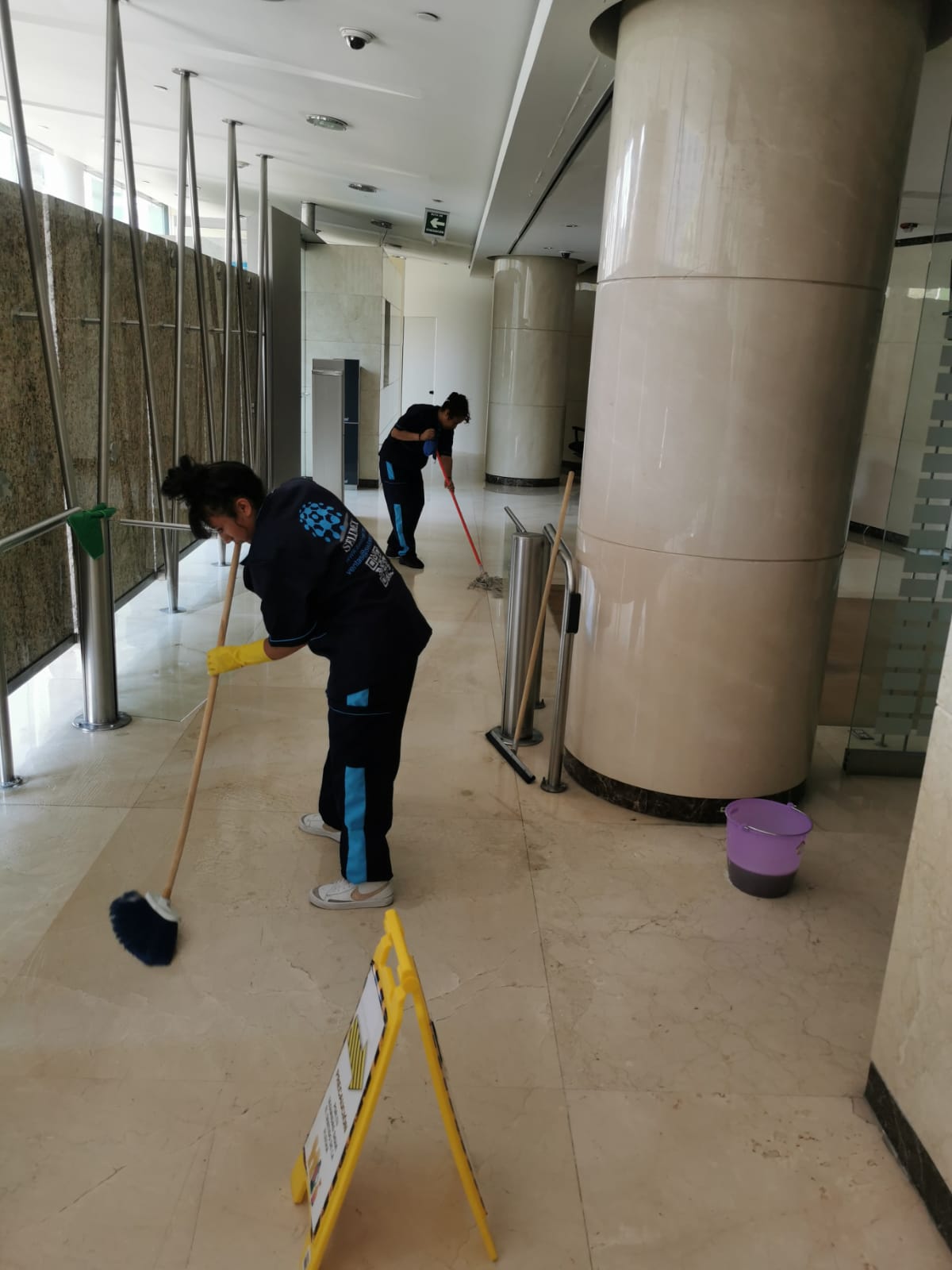 Staff in SELIMEX uniforms cleaning an interior